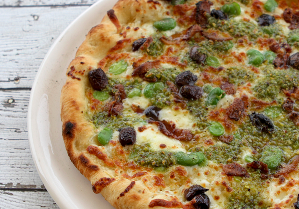 Pizza With Fava Bean Pesto, Fresh Fava Beans, Black Olives & Taleggio Cheese